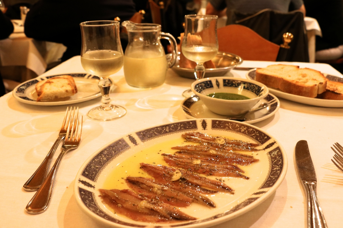 Sardines, pesto, and white wine at dinner